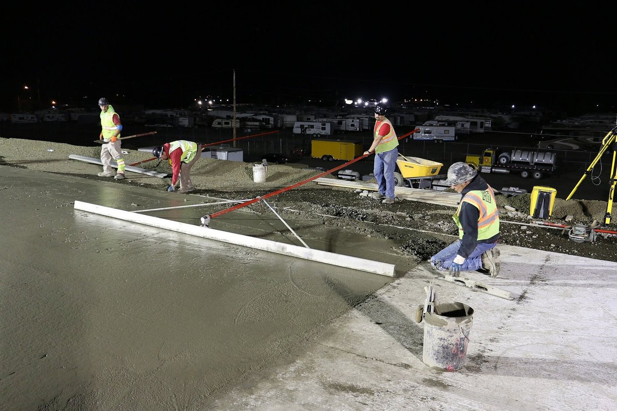 A concrete crew finishing a fresh slab