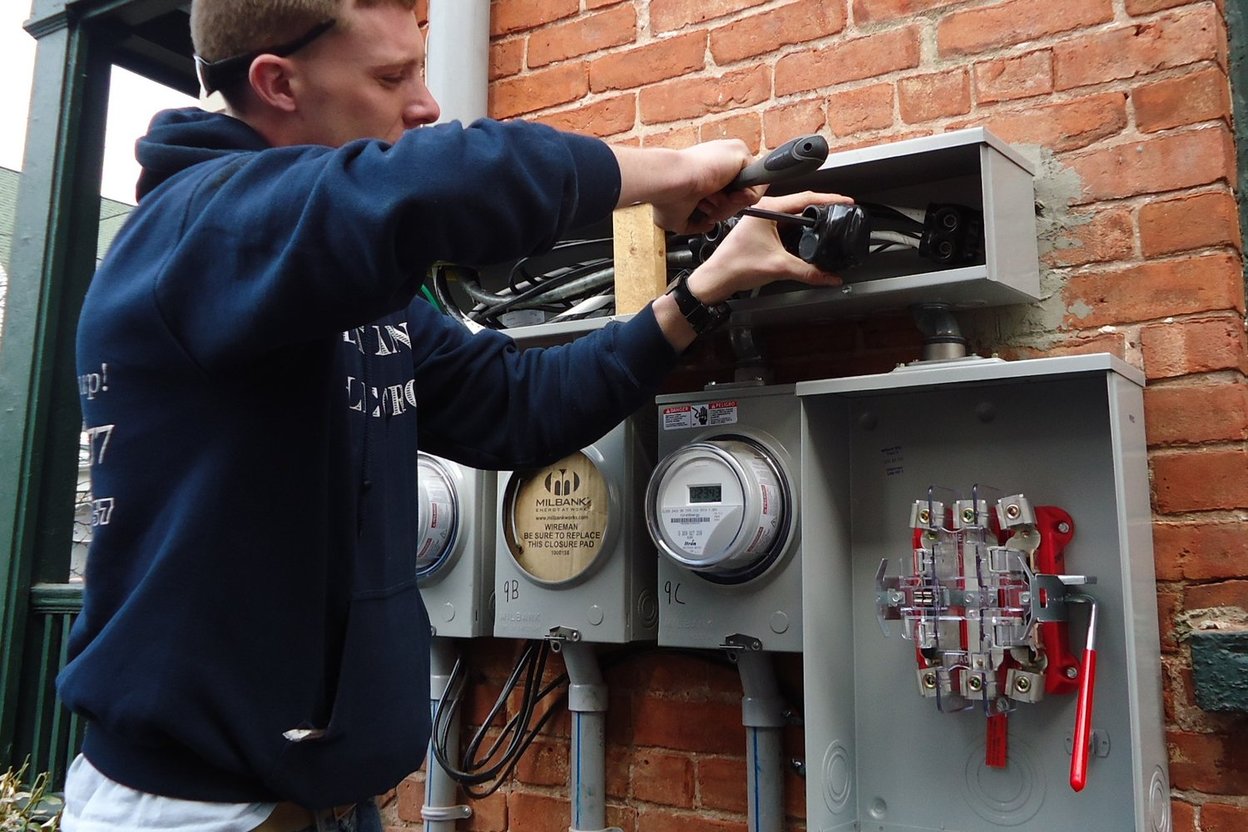 An electrician working on a residential electrical panel