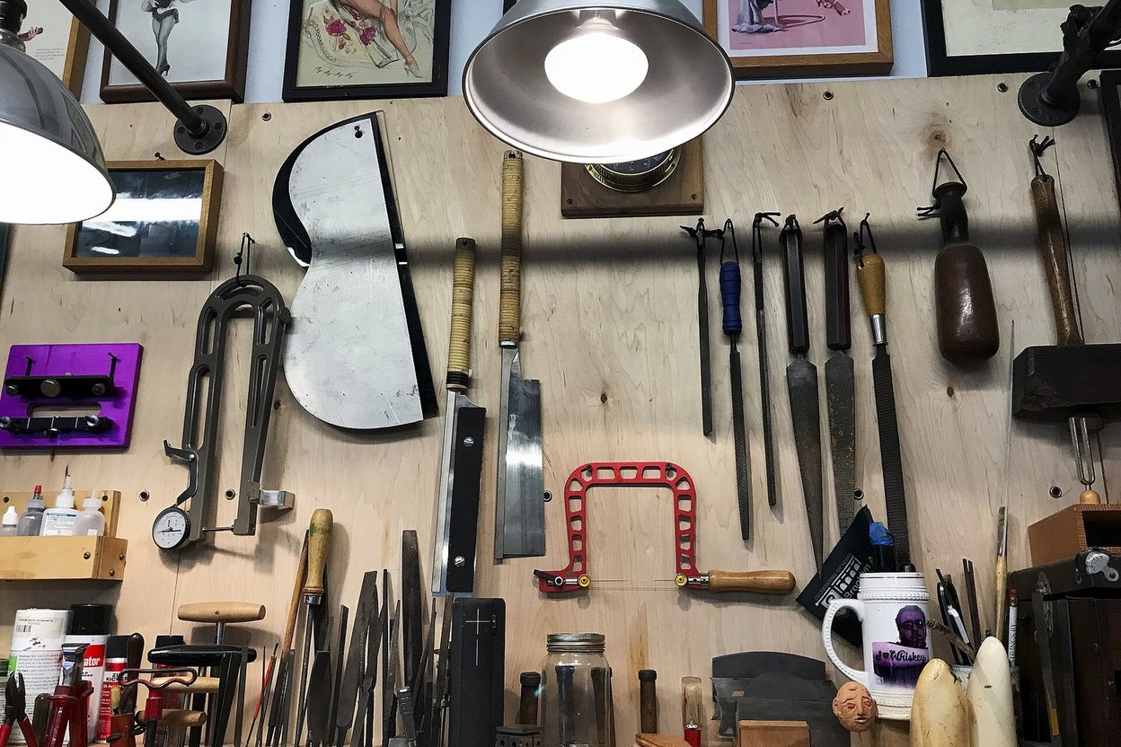A handyman's tools laid out on a workbench