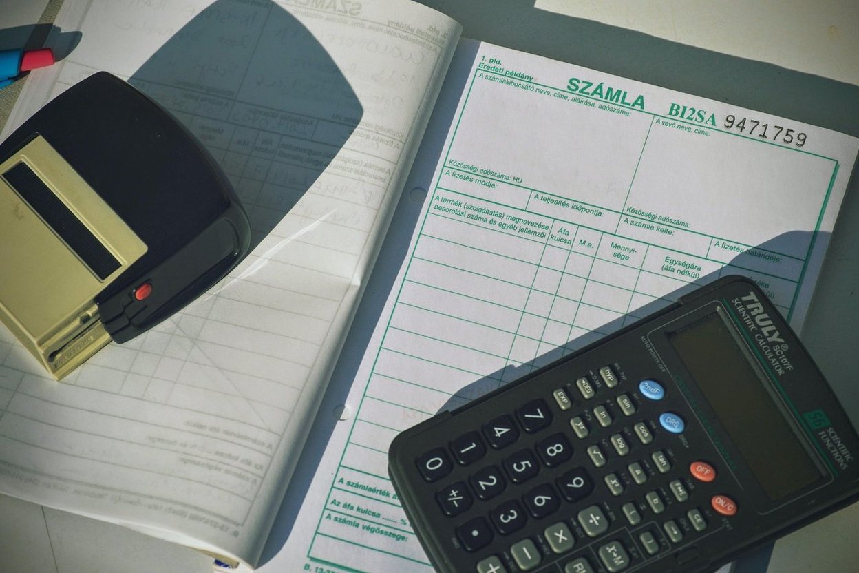 A calculator on top of invoices and receipts