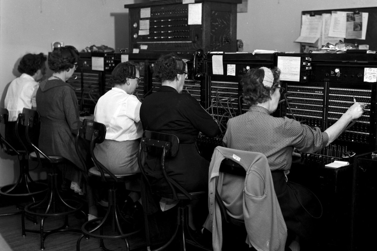 Switchboard operators connecting calls in 1958