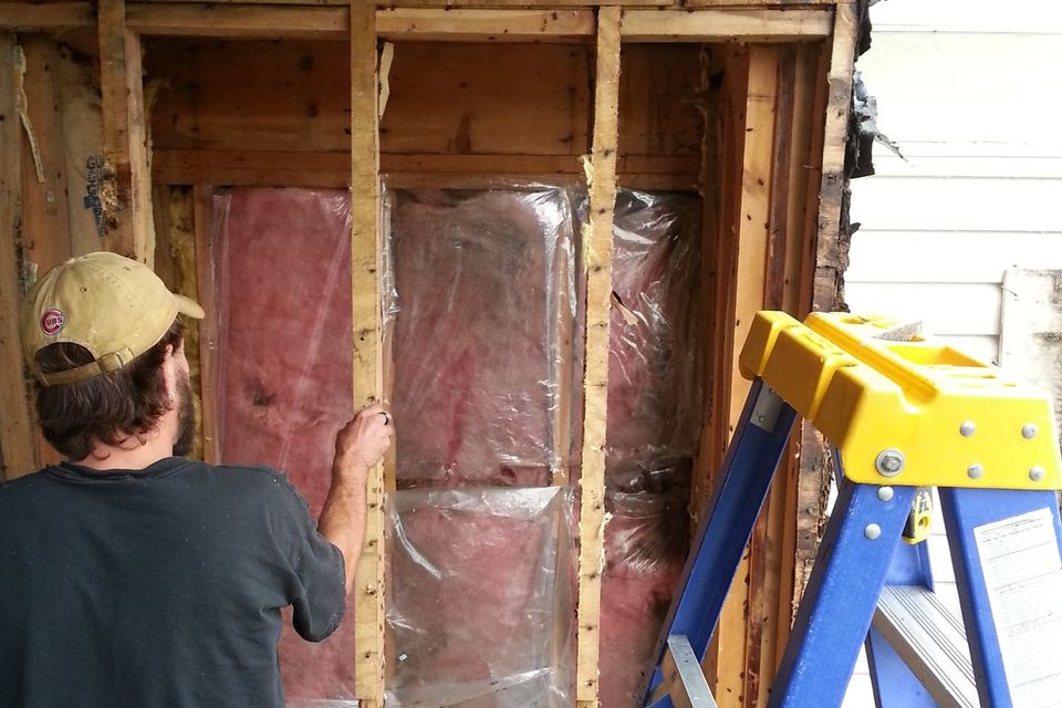 The wall opened up to the framing to fix the rot